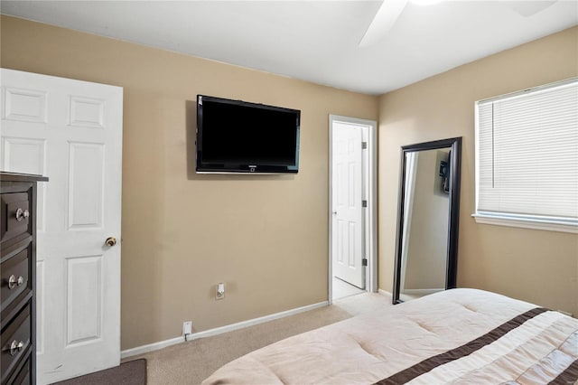 carpeted bedroom with baseboards and ceiling fan