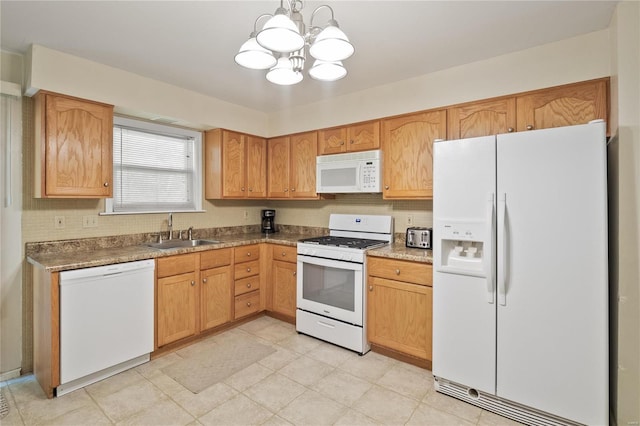 kitchen featuring white appliances, a sink, a chandelier, pendant lighting, and tasteful backsplash