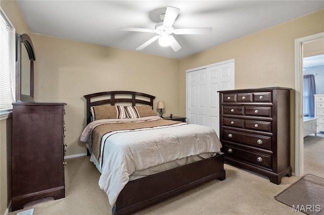 12063 Trampe Heights Ln, Saint Louis, MO 63138 - bedroom with light carpet, a closet, a ceiling fan, and baseboards