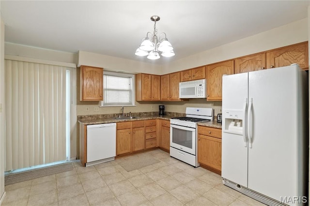 12063 Trampe Heights Ln, Saint Louis, MO 63138 - kitchen with white appliances, a sink, a chandelier, hanging light fixtures, and brown cabinetry