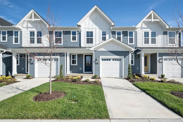 townhome / multi-family property with concrete driveway, board and batten siding, a front yard, and a garage