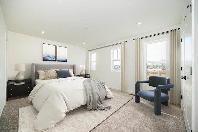 bedroom featuring light carpet, baseboards, and recessed lighting