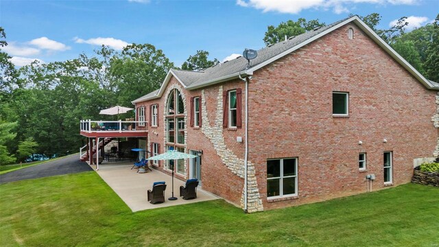 472 Ridgefield Dr, Cape Girardeau, MO 63701 - view of side of home featuring a wooden deck, a patio area, a lawn, and brick siding