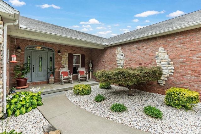 472 Ridgefield Dr, Cape Girardeau, MO 63701 - view of exterior entry with covered porch, roof with shingles, and brick siding