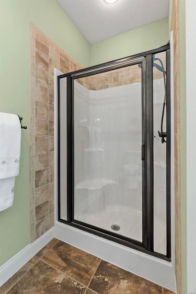 472 Ridgefield Dr, Cape Girardeau, MO 63701 - bathroom featuring a shower stall and stone tile flooring