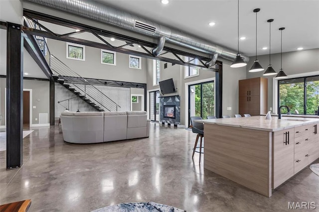 173 Tate Rdg, Cape Girardeau, MO 63701 - kitchen featuring a towering ceiling, finished concrete floors, recessed lighting, open floor plan, and a spacious island