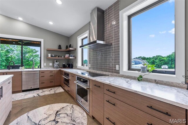 173 Tate Rdg, Cape Girardeau, MO 63701 - kitchen featuring stainless steel appliances, wall chimney exhaust hood, healthy amount of natural light, vaulted ceiling, and light stone counters