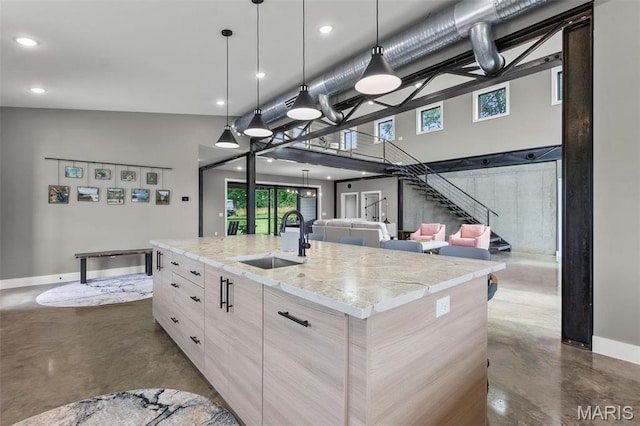 173 Tate Rdg, Cape Girardeau, MO 63701 - kitchen featuring finished concrete flooring, a center island with sink, open floor plan, recessed lighting, and light stone counters