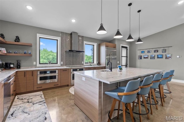 173 Tate Rdg, Cape Girardeau, MO 63701 - kitchen with wall chimney range hood, appliances with stainless steel finishes, modern cabinets, finished concrete flooring, and healthy amount of natural light