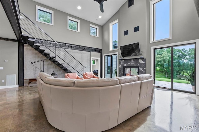 173 Tate Rdg, Cape Girardeau, MO 63701 - living area with a towering ceiling, finished concrete flooring, ceiling fan, stairway, and recessed lighting