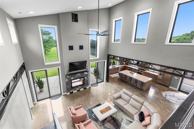 173 Tate Rdg, Cape Girardeau, MO 63701 - living room featuring a high ceiling, plenty of natural light, recessed lighting, and a premium fireplace
