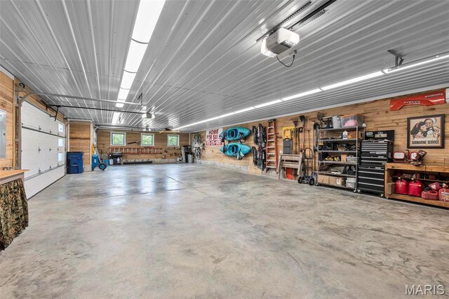 173 Tate Rdg, Cape Girardeau, MO 63701 - garage with a garage door opener and wood walls