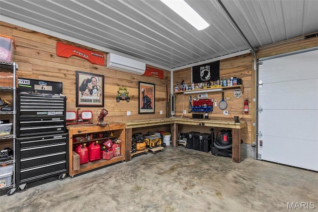 173 Tate Rdg, Cape Girardeau, MO 63701 - garage featuring a workshop area, a wall mounted air conditioner, and wooden walls