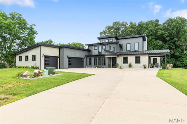 173 Tate Rdg, Cape Girardeau, MO 63701 - view of front of home with an attached garage, a standing seam roof, concrete driveway, board and batten siding, and a front yard