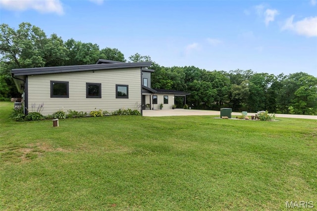 173 Tate Rdg, Cape Girardeau, MO 63701 - rear view of property featuring a patio area and a lawn
