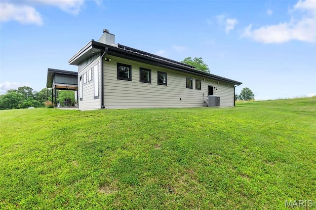 173 Tate Rdg, Cape Girardeau, MO 63701 - back of property featuring a lawn and a chimney