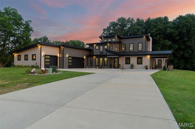 173 Tate Rdg, Cape Girardeau, MO 63701 - contemporary house featuring a garage, concrete driveway, a front lawn, and board and batten siding