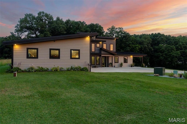 173 Tate Rdg, Cape Girardeau, MO 63701 - back of property at dusk with a patio area and a yard
