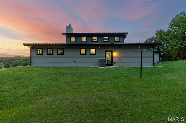 173 Tate Rdg, Cape Girardeau, MO 63701 - back of property featuring a chimney, a yard, and a metal roof
