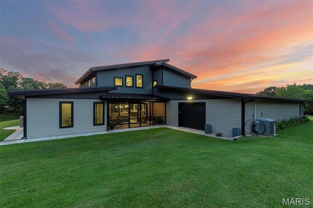 173 Tate Rdg, Cape Girardeau, MO 63701 - rear view of house with a yard, a standing seam roof, an attached garage, and a metal roof