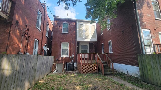 3253 Texas Ave, Saint Louis, MO 63118 - rear view of house featuring fence, central air condition unit, and brick siding