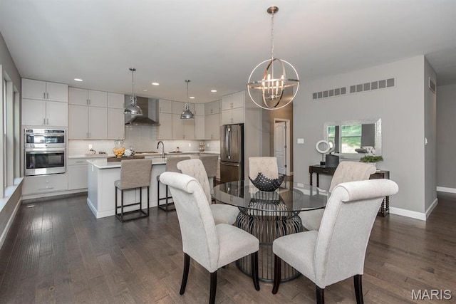 2708 Brook Hill Ln, Saint Charles, MO 63303 - dining area with a chandelier, dark wood-type flooring, recessed lighting, and baseboards