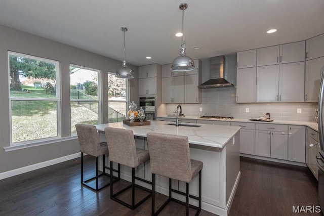 2708 Brook Hill Ln, Saint Charles, MO 63303 - kitchen with wall chimney range hood, a sink, stainless steel gas cooktop, plenty of natural light, and recessed lighting