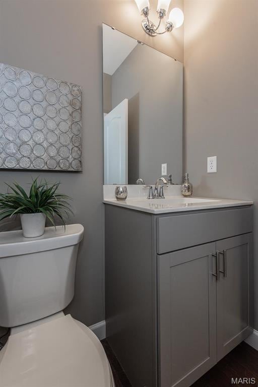 2708 Brook Hill Ln, Saint Charles, MO 63303 - half bathroom featuring toilet, vanity, and baseboards