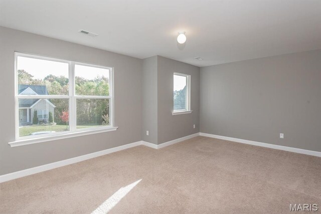 2708 Brook Hill Ln, Saint Charles, MO 63303 - spare room with healthy amount of natural light, light colored carpet, and baseboards