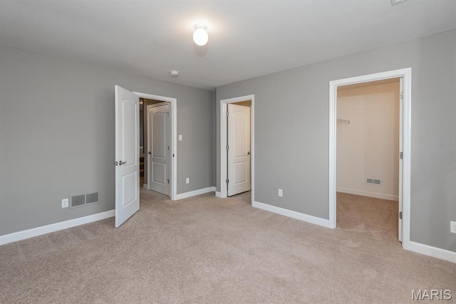 2708 Brook Hill Ln, Saint Charles, MO 63303 - unfurnished bedroom with a walk in closet, light carpet, baseboards, and a closet