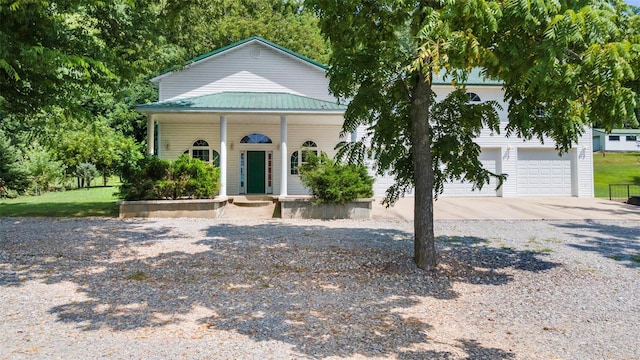 10912 State Highway 77, Chaffee, MO 63740 - view of front of home with concrete driveway, metal roof, an attached garage, and a porch