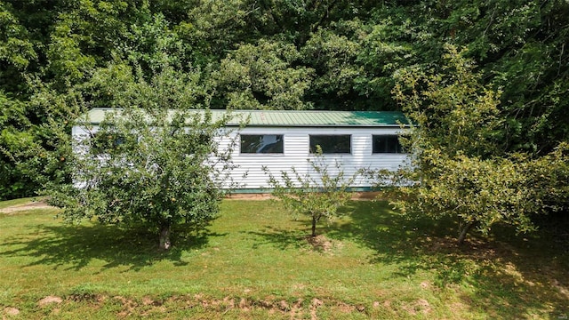 10912 State Highway 77, Chaffee, MO 63740 - view of side of property with a lawn and metal roof