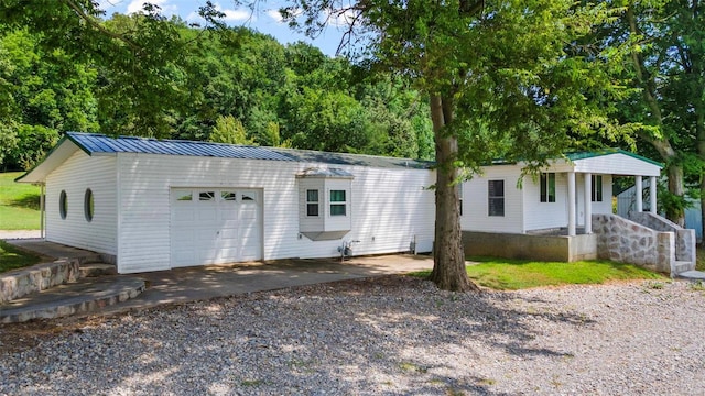 10912 State Highway 77, Chaffee, MO 63740 - view of front of home featuring an attached garage, driveway, and metal roof