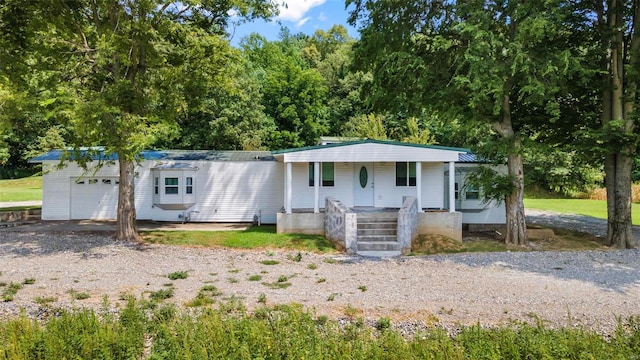 10912 State Highway 77, Chaffee, MO 63740 - view of front of home featuring a porch, a garage, and driveway