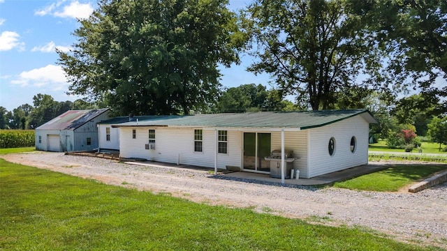 10912 State Highway 77, Chaffee, MO 63740 - back of house featuring a lawn, metal roof, and a patio