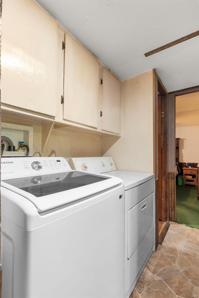 10912 State Highway 77, Chaffee, MO 63740 - clothes washing area featuring cabinet space, separate washer and dryer, and light stone finish flooring
