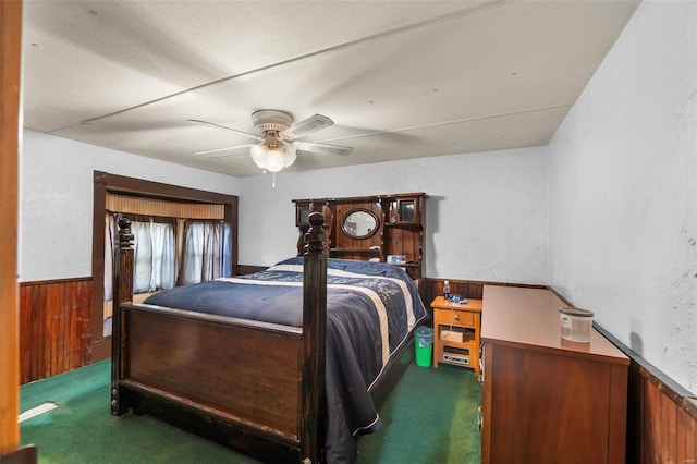 10912 State Highway 77, Chaffee, MO 63740 - carpeted bedroom with wood walls, a wainscoted wall, and a ceiling fan
