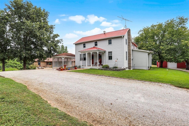 7102 Shadow Ln, Villa Ridge, MO 63089 - view of front of home featuring a gazebo, gravel driveway, a front yard, metal roof, and a porch