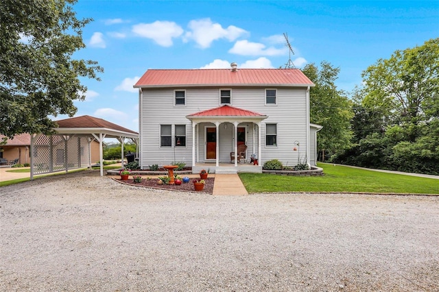 7102 Shadow Ln, Villa Ridge, MO 63089 - view of front of home featuring a front lawn, a porch, gravel driveway, a detached carport, and metal roof