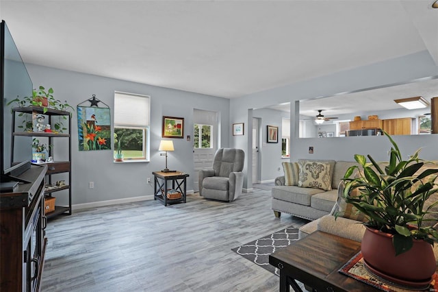 7102 Shadow Ln, Villa Ridge, MO 63089 - living room with light wood-style flooring, baseboards, and a ceiling fan
