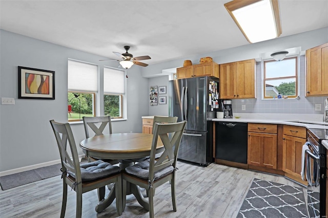 7102 Shadow Ln, Villa Ridge, MO 63089 - kitchen with black appliances, a sink, healthy amount of natural light, and light wood-type flooring