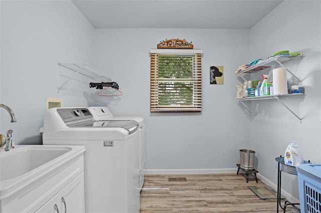 7102 Shadow Ln, Villa Ridge, MO 63089 - laundry area featuring washing machine and clothes dryer, light wood-style flooring, and baseboards