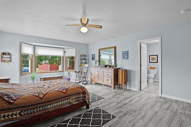 7102 Shadow Ln, Villa Ridge, MO 63089 - bedroom with light wood finished floors, baseboards, ensuite bath, and a ceiling fan