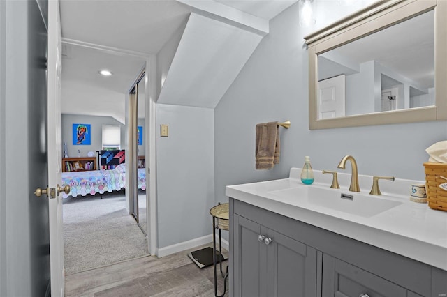 7102 Shadow Ln, Villa Ridge, MO 63089 - ensuite bathroom featuring wood finished floors, vanity, recessed lighting, and baseboards