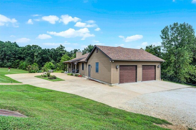 7102 Shadow Ln, Villa Ridge, MO 63089 - view of side of home featuring a chimney, concrete driveway, a yard, and an attached garage
