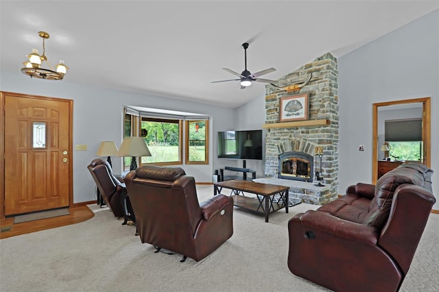 7102 Shadow Ln, Villa Ridge, MO 63089 - carpeted living room featuring a chandelier, ceiling fan, a fireplace, baseboards, and high vaulted ceiling