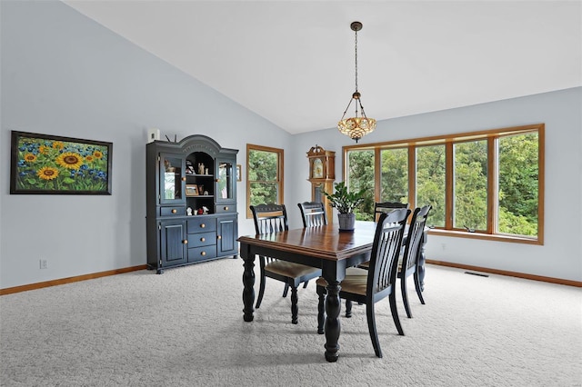 7102 Shadow Ln, Villa Ridge, MO 63089 - dining space featuring light colored carpet, baseboards, lofted ceiling, and a chandelier