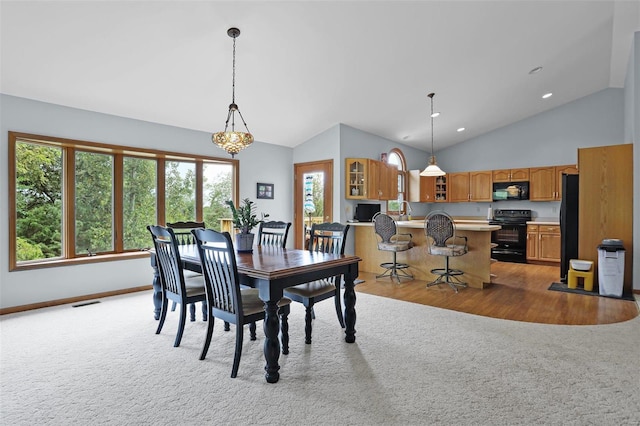 7102 Shadow Ln, Villa Ridge, MO 63089 - dining area featuring light carpet, healthy amount of natural light, baseboards, high vaulted ceiling, and recessed lighting