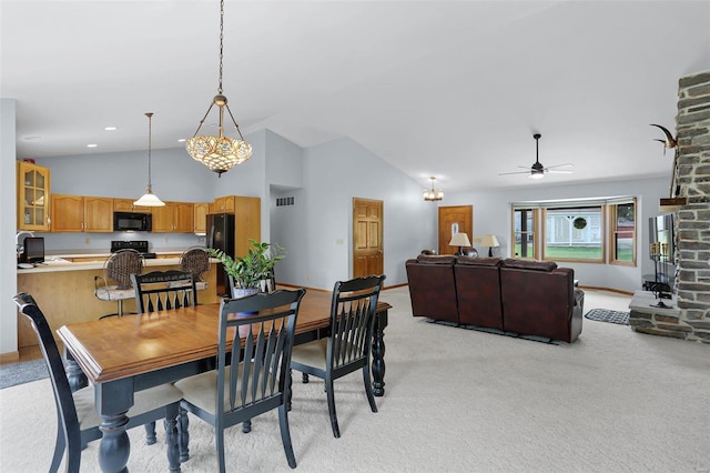 7102 Shadow Ln, Villa Ridge, MO 63089 - dining space with light carpet, ceiling fan, baseboards, and high vaulted ceiling