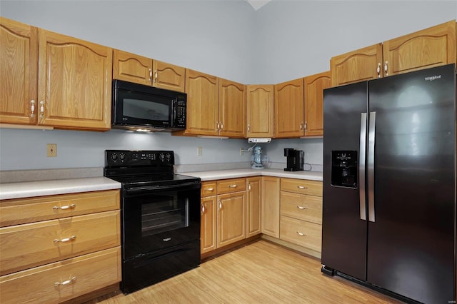 7102 Shadow Ln, Villa Ridge, MO 63089 - kitchen with black appliances, light countertops, and light wood-style flooring